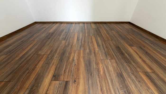 Laminated wood floor with white wall. Empty room with floating l