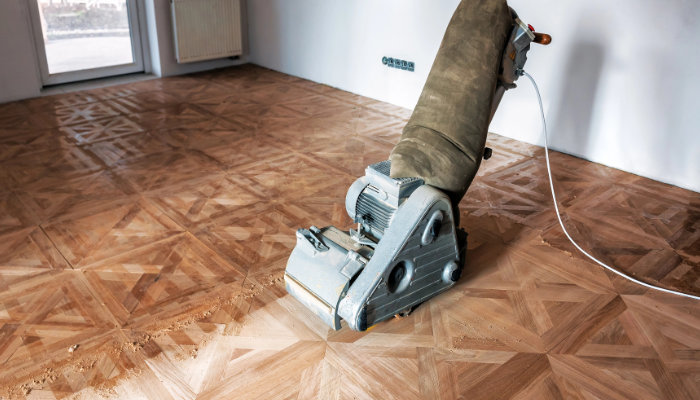 Sanding hardwood floor with the grinding machine.