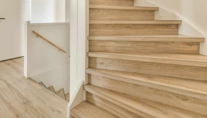 a staircase in a home with white walls and wood